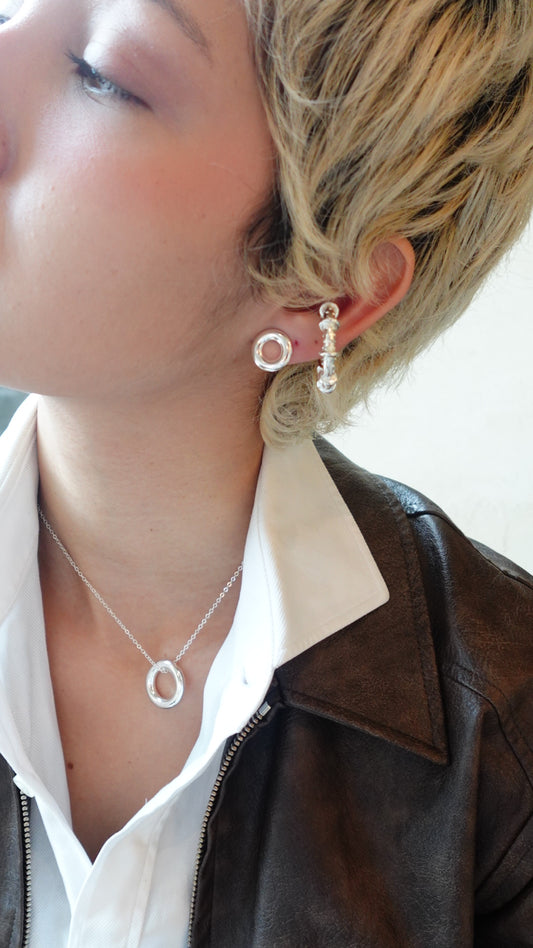 silver circle necklace and earrings matching each other